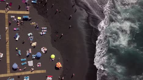 aerial top down tenerife playa de la arena black sandy tropical beach holiday summer destination in spain