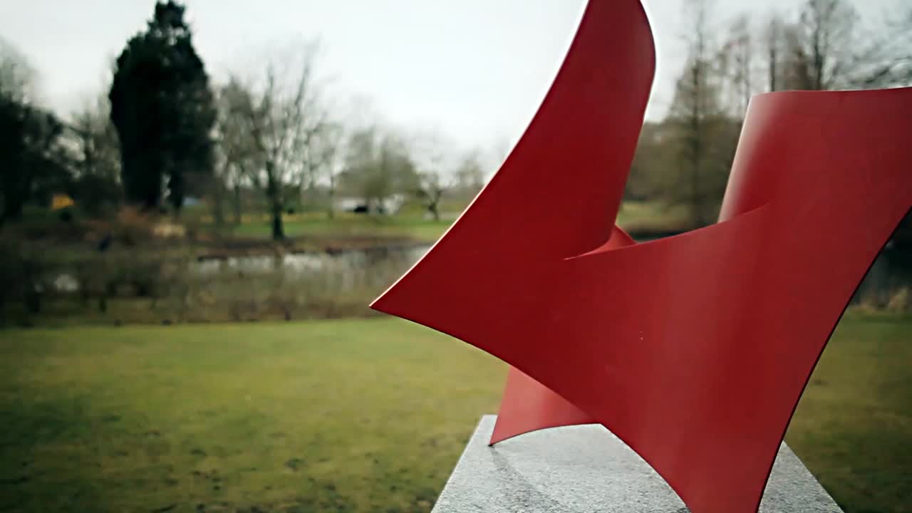 Red Abstract Sculpture in a Park