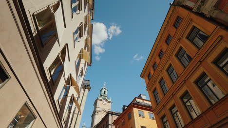 st nicholas (storkyrkan) bell tower in stockholm view through a narrow street with old houses 4k vid