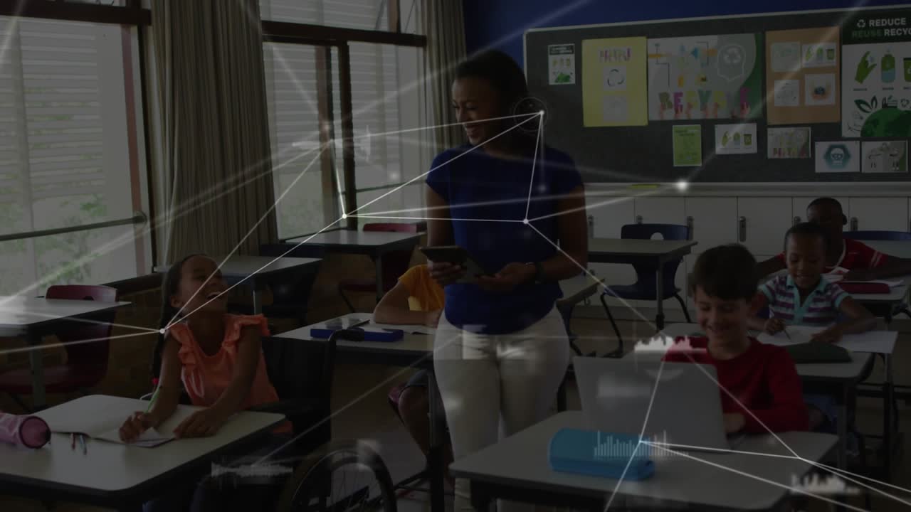 Teacher checking tablet glancing at students and activating network overlay across desks for school