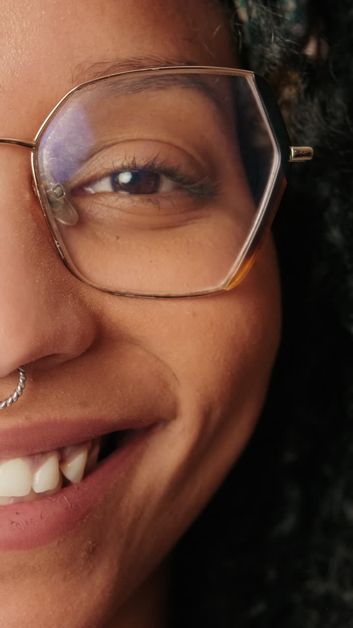 Close-up of a Smiling Woman Wearing Glasses and a Nose Ring