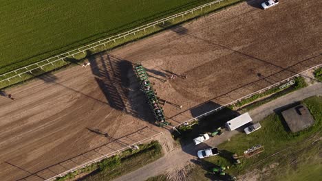 Aerial-top-down-shot-during-start-of-horse-race-on-racetrack-during-summer---Buenos-Aires,Argentina