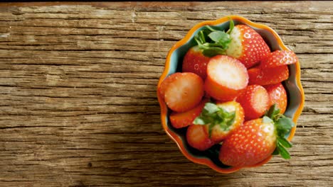 bowl full of slice strawberries on wooden floor 4k 4k