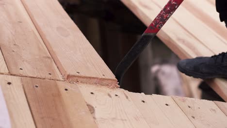 removing wooden planks from a floor during construction