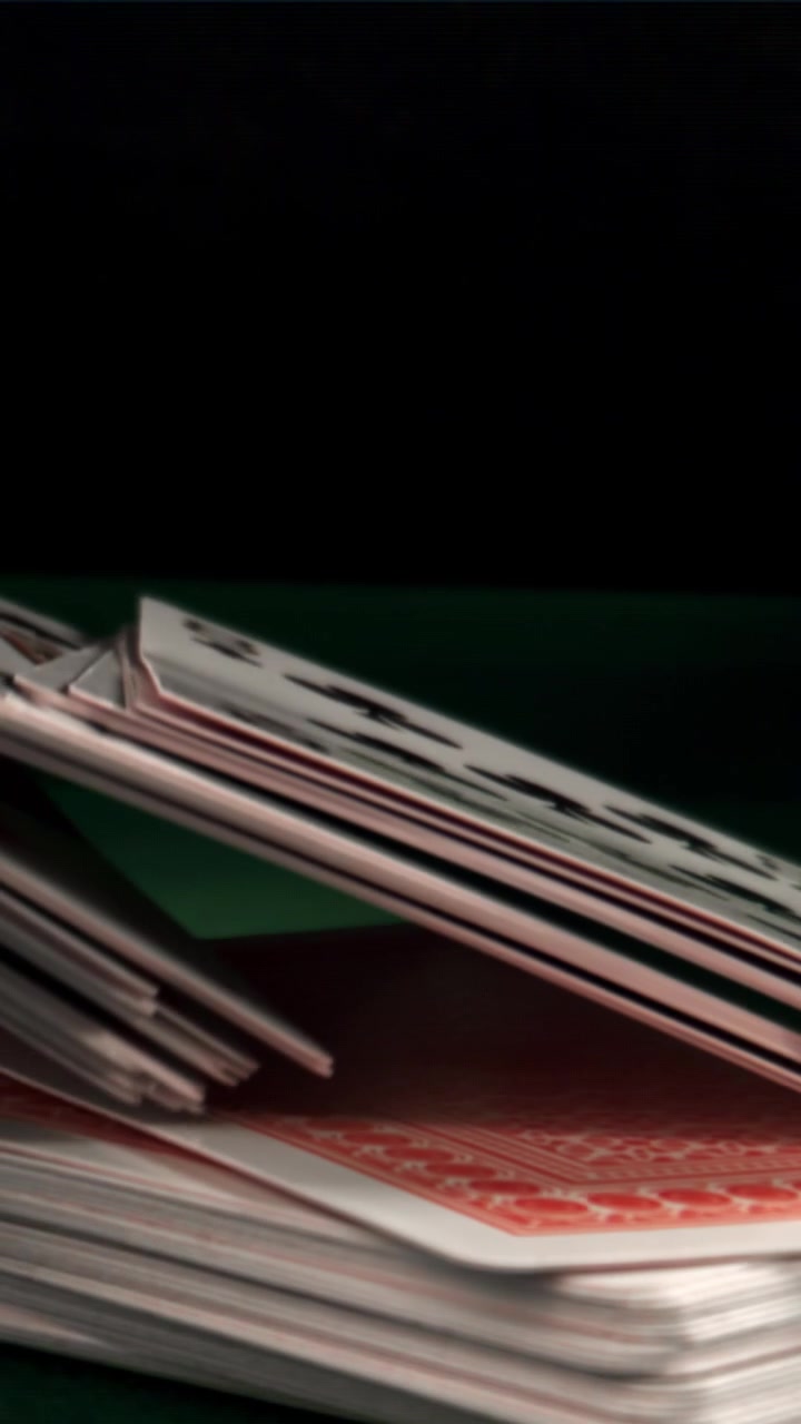 Slow Motion Reveal of Playing Cards on a Green Table