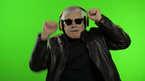 Elderly-senior-caucasian-grandfather-biker-man-dance,-listen-music.-Chroma-key