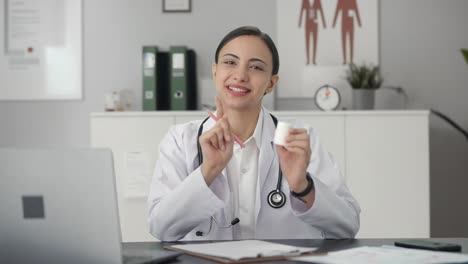 Happy-Indian-female-doctor-giving-medicine-to-patient