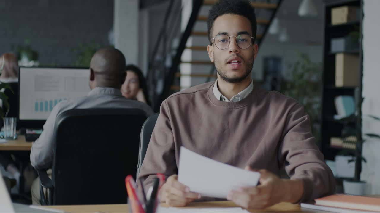 Young professional reviewing documents in a modern office