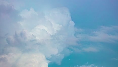 timelapse of fluffy cumulonimbus clouds ascending in the vast blue sky