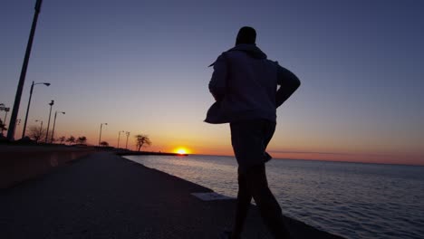 silhouette of african american male running at sunset