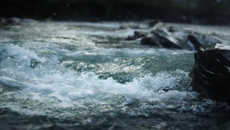 surface of mountain river water splashing. abundant stream flowing in nature.