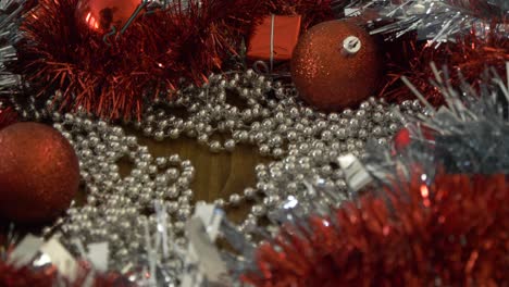 zooming in on christmas decorations on a table and picking up a silver bauble