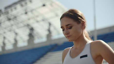 A-time-lapse-portrait-of-beautiful-woman-running-on-the-stadium-bleachers-with-concentrated-deep-breathing-and-motivating-myself-and-consciousness-for-the-race.-Discard-unnecessary-emotions-and-tune-in-to-win-preparing-for-the-race