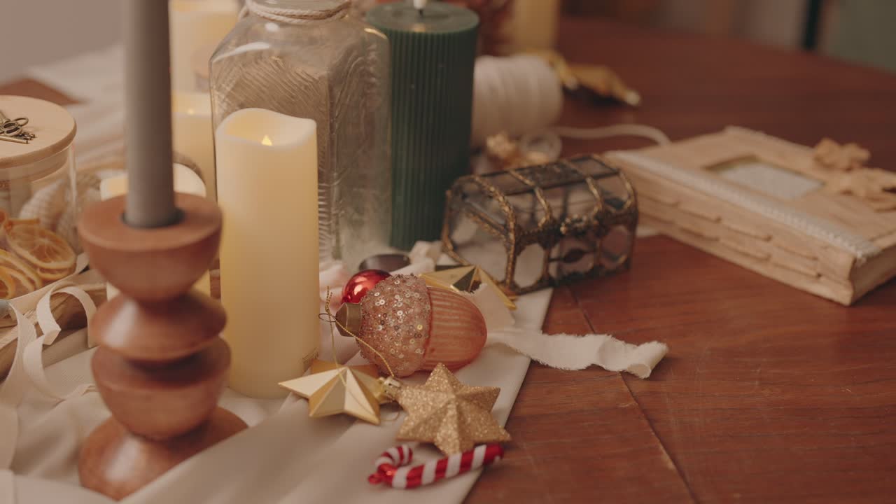 Cozy festive still life with glowing candles ornaments and decorations