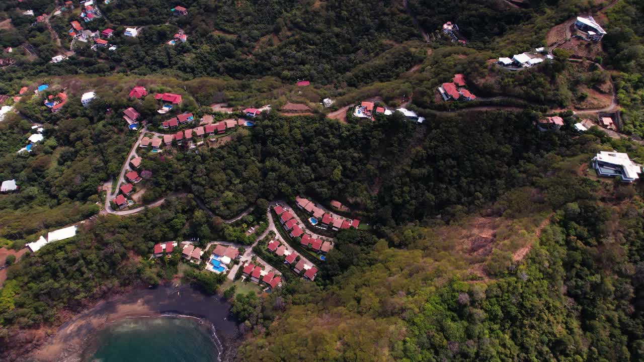 Drone approaching to coastal residential area of semi-detached houses in Costa Rica's nature
