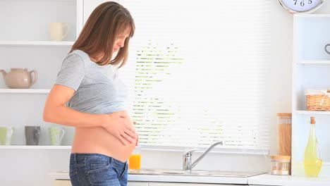 pregnant woman holding her tummy