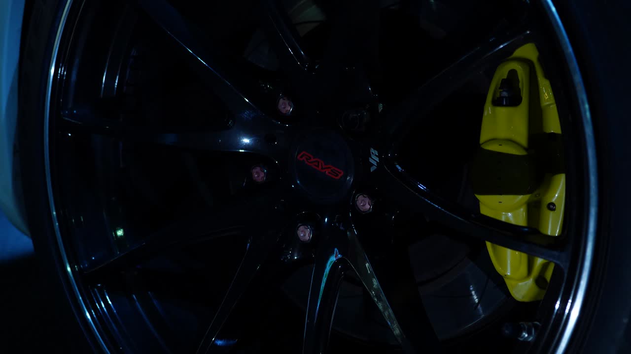 Car wheel with Rays brand and yellow brake calipers