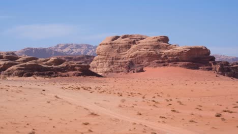 Hostile-planet-Mars-like-red-desert-of-Wadi-Rum-in-Jordan-with-vast,-barren,-rugged-rocky-mountainous-landscape