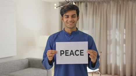 happy indian boy holding peace banner