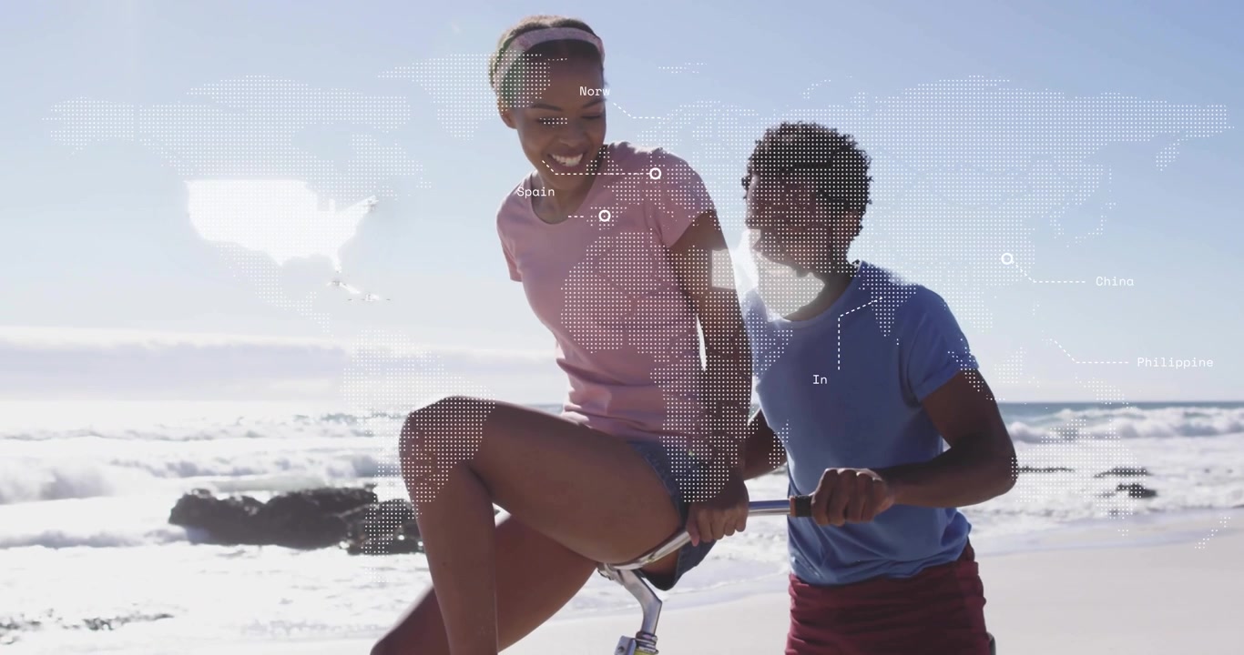 couple riding bicycle on beach displaying dotted world map overlay highlighting global business