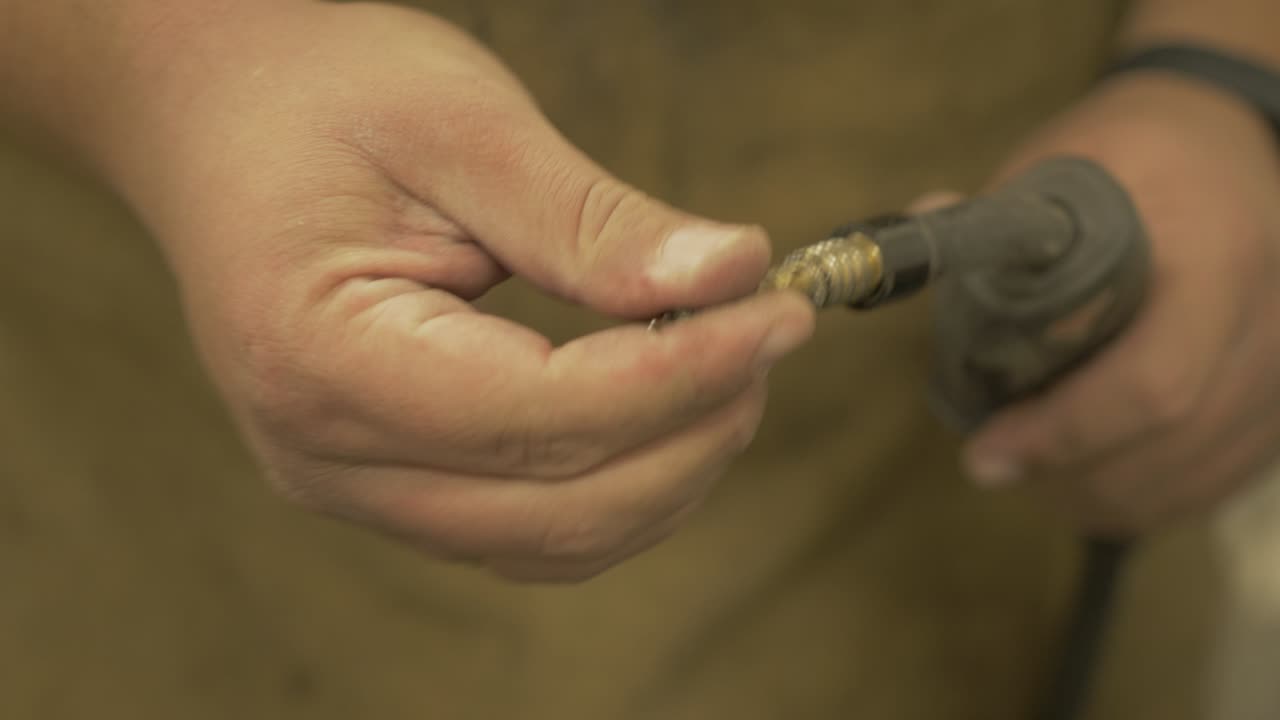 Changing tip of MIG welding gun nozzle Medium Shot