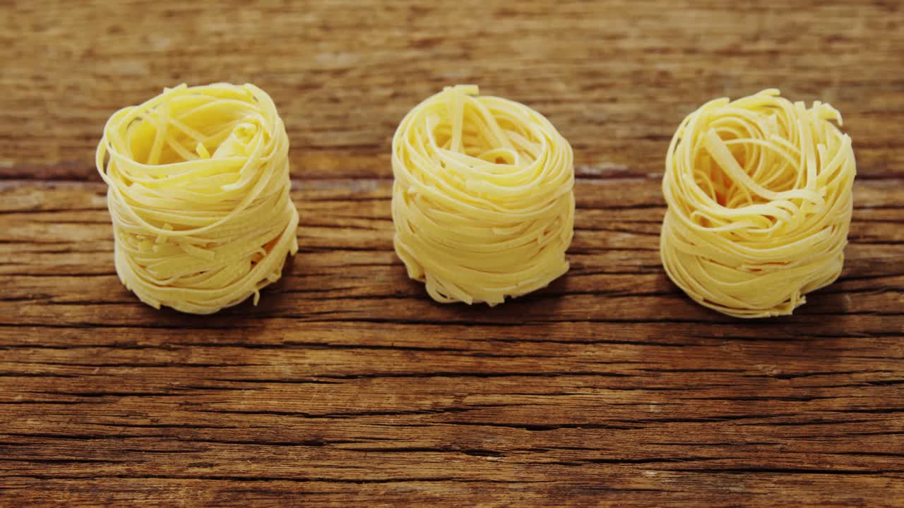 Roll of spaghetti on wooden table