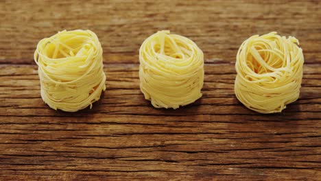 roll of spaghetti on wooden table