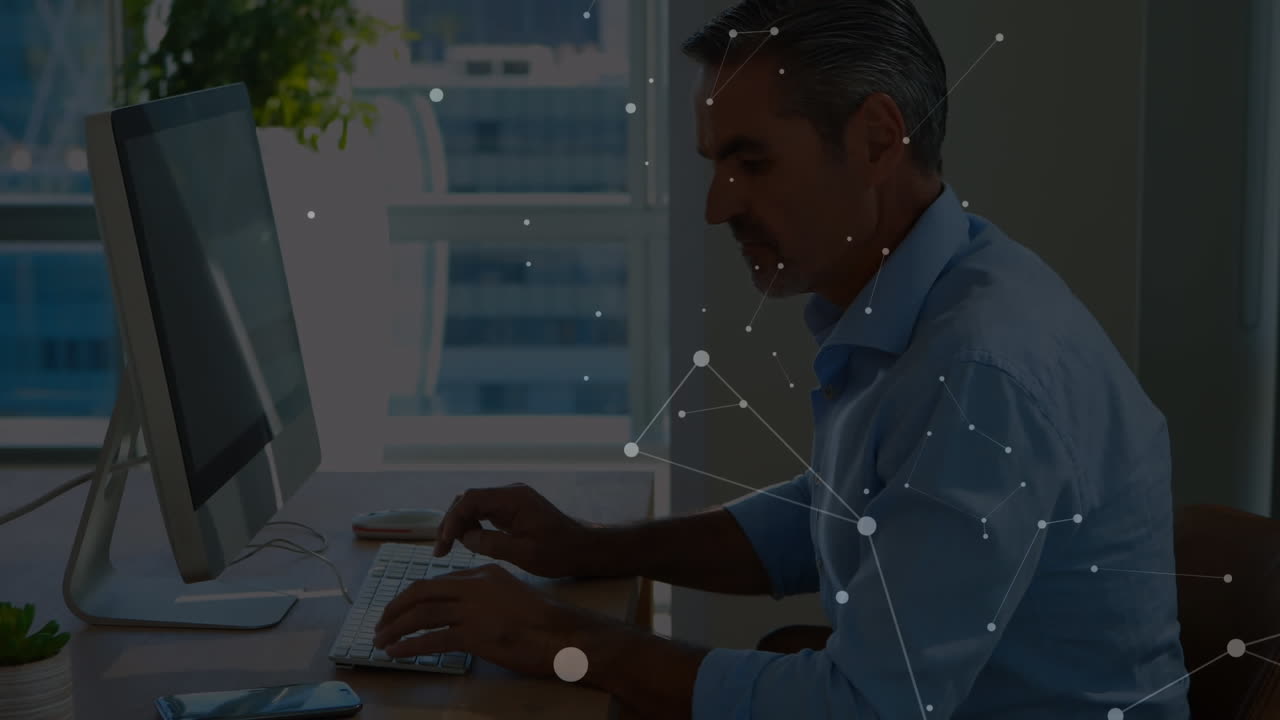 Animation of connected dots on caucasian man talking on cellphone and working on compute