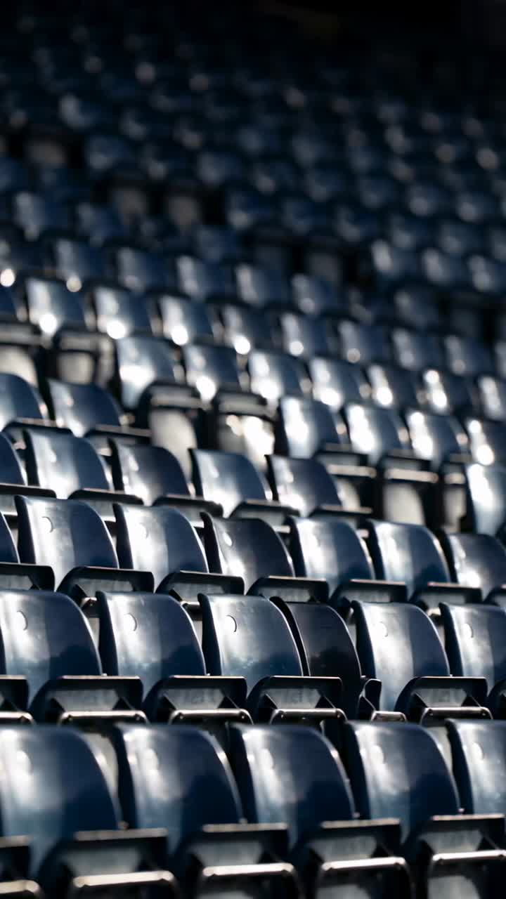Vertical video: Moving camera shifting in stand, showing navy seats and frames, revealing layers