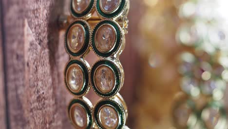 close-up of indian gold bangles with gems