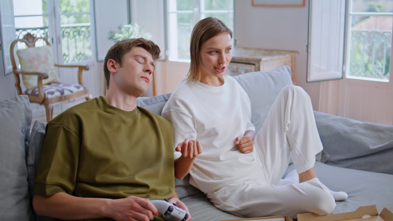 Video players sitting sofa man holding console at home closeup. Competing online