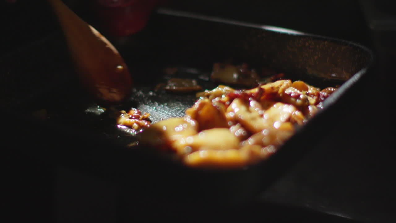 Stirring food in a pan with a wooden spoon