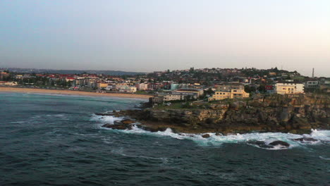 aerial drone shot of ben buckler rocks and the ocean in bondi, sydney australia