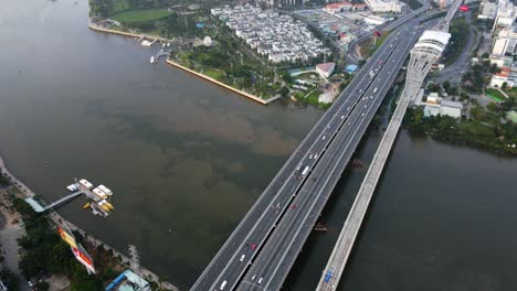 aerial view overlooking cau sai gon bridge revealing skyscrapers in the phuong 22 district of ho chi minh, vietnam - tilt, drone shot