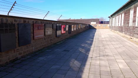 mauthausen, upper austria - memorial plaques at mauthausen concentration camp - drone flying forward