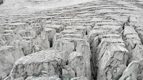 aerial flyover over the moiry glacier near grimentz in valais, switzerland with a pan down view straight into a crevasse