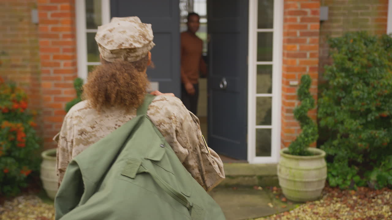 American Female Soldier Returns Home To Family On Leave Hugging Husband Outside House