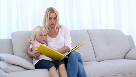 mother and daughter reading a book together