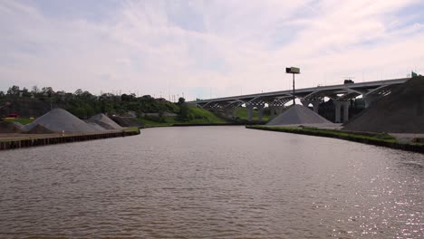 cuyahoga river in cleveland ohio has industry all along the bulkhead and shoreline with many bridges spanning over the waterway