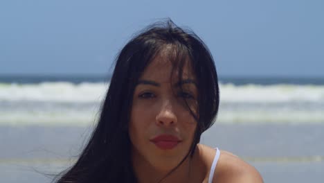 a bikini-clad young girl enjoys the sunshine on a tropical island beach facial close up