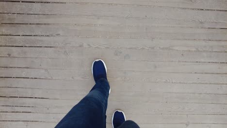 person walking on a wooden deck