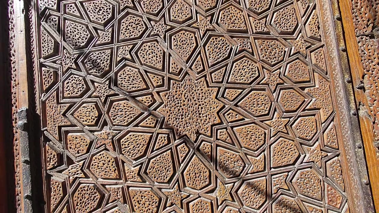 Intricate Geometric Wood Carving on Ancient Door