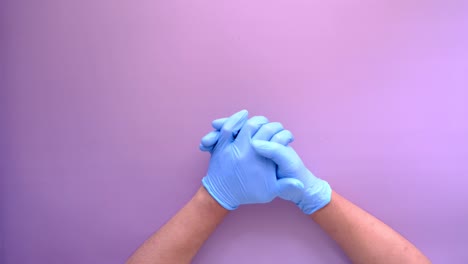 hands in blue medical gloves