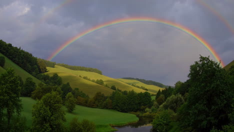 double rainbow over a lush valley