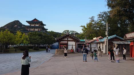 children and families at national folk museum, street of memories in seoul, south korea. pan left shot