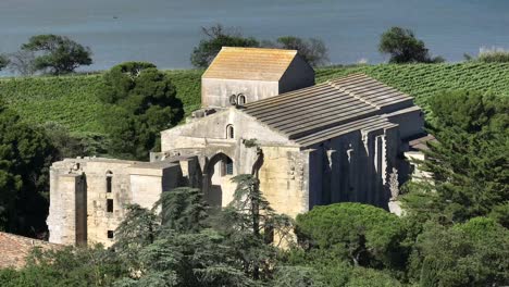 French-coastal-town-of-Maguelone-and-its-cathedral-seen-closer,-Aerial-dolly-out-reveal-shot