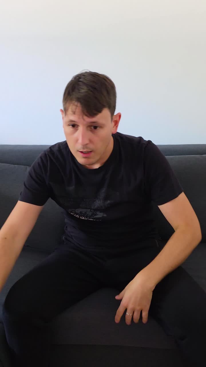 Vertical: caucasian man playing video game and rage quitting, medium shot