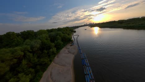 fpv drone shot over the shore of the beach of vistula river, warsaw, poland