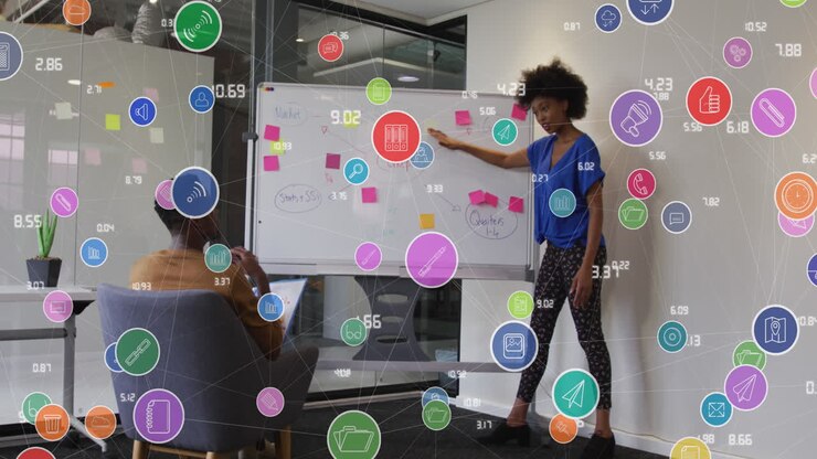 Animation of network of connections with icons over diverse business people in office