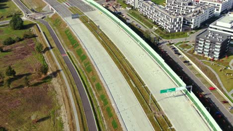 drone shot highway motorway showing lanes with tunnel and viaducts outside the city of warsaw, poland